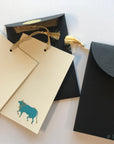 Unwritten 4 - handcrafted stationery set, black A7 gold liner envelopes, bookmark style notes, blue Nandi cow print, gold tassels - Set of 6