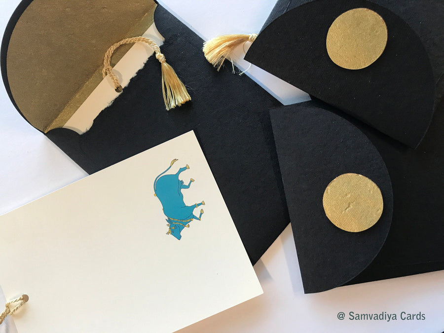 Unwritten 4 - handcrafted stationery set, black A7 gold liner envelopes, bookmark style notes, blue Nandi cow print, gold tassels - Set of 6