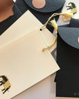 Unwritten 5- handcrafted stationery set, black A7 copper liner envelopes, bookmark style notes, black elephant print, gold tassels- Set of 6