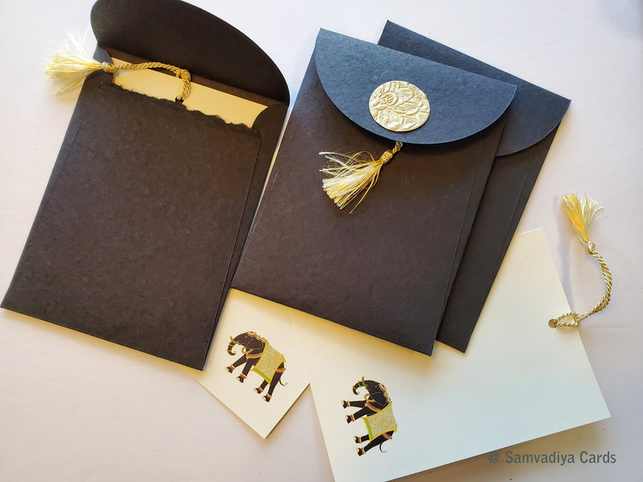 Unwritten 2- handcrafted stationery set, natural black paper A7 envelopes with bookmark style notes, elephant design, gold tassels- Set of 6